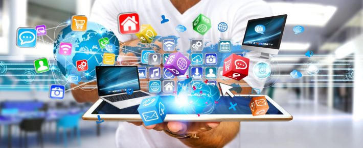 Businessman holding multimedia tech devices in his hand