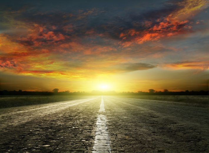 Long country road with white lines down the centre stretching of