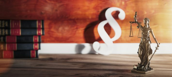 Statue of Justice – lady justice or Iustitia / Justitia the Roman goddess of Justice with Paragraph Symbol in a lawyer office, banner size